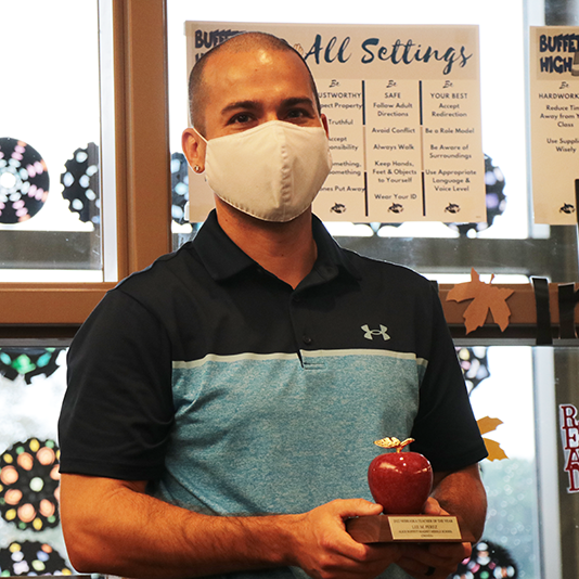  Lee Perez holds his Teacher of the Year award